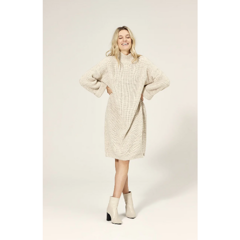 knitted dress is made from a soft acrylic wool blend and features a stand-up rib-knit polo neck that keeps you warm even on the coldest days. The slightly fitted shape creates a beautiful, feminine silhouette, while the folded cuffs and high side slits add a playful touch. 